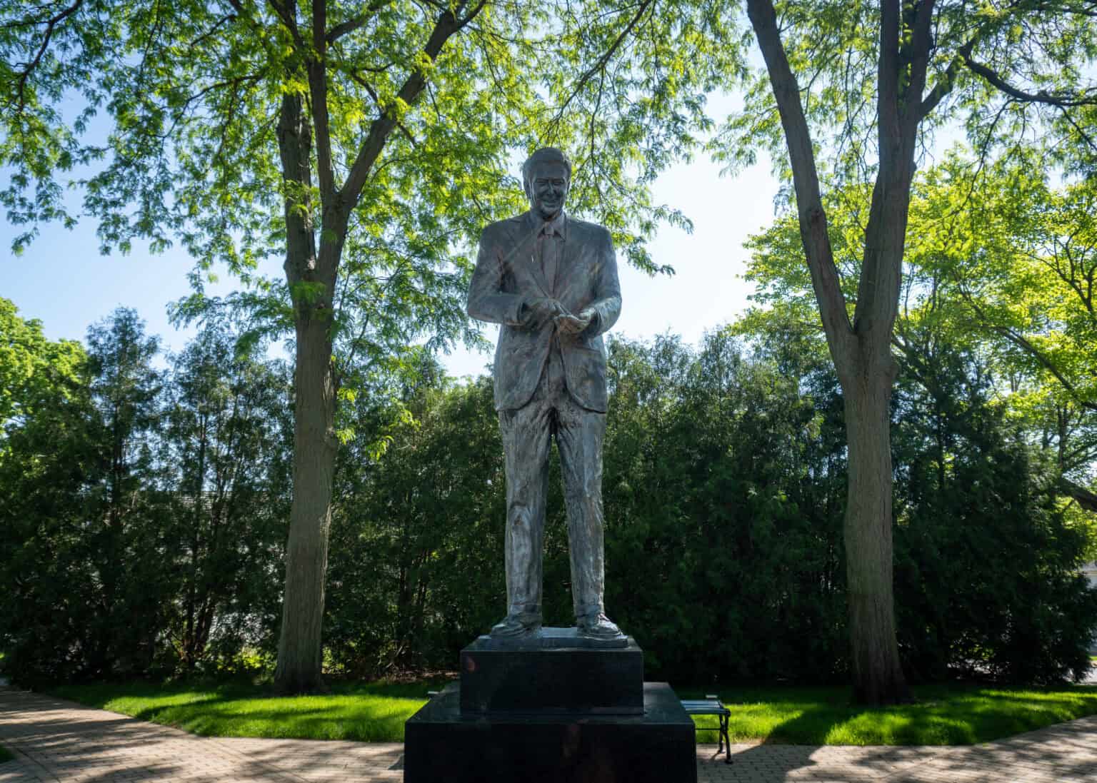 Statue of Ronald Reagan at his Boyhood Home in which the 40th President of the United States Ronald Reagan lived as a youth. Admiring kernels of corn in his hand.
